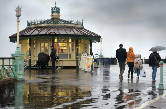 People walking along wet pathway, victorian kisok with PVCu render beading