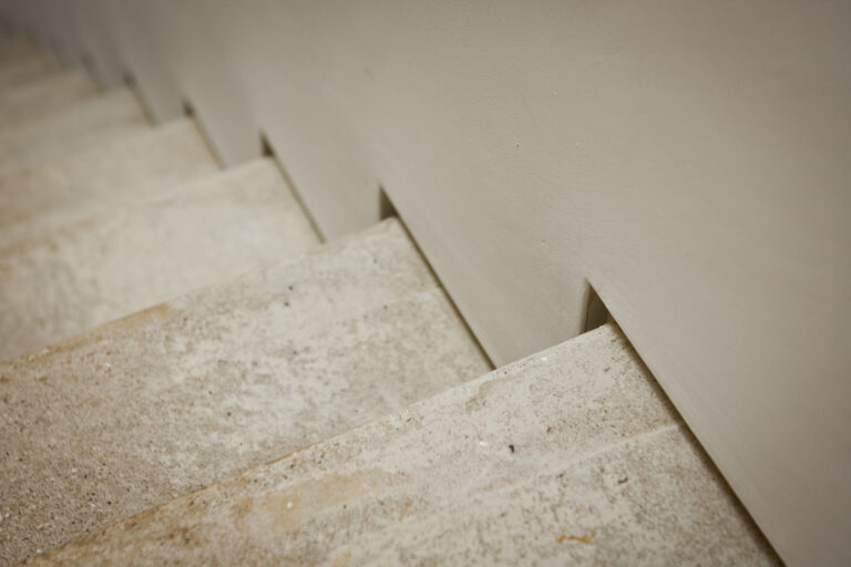 Close up high resolution image of stairs with high quality shadow gap bead with plaster finish