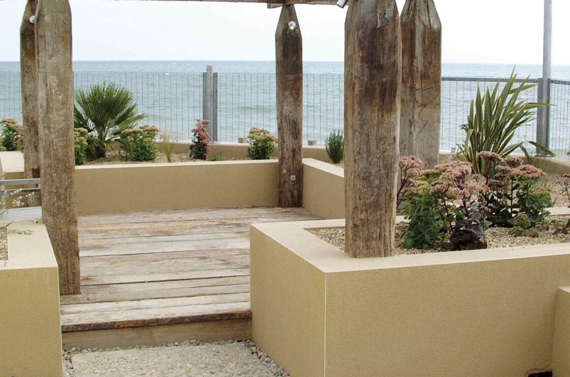 Italian garden with wooden arch structure and small rendered walls with PVCu beading