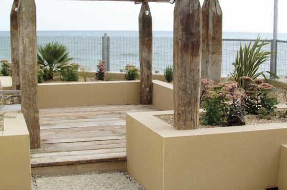 Italian garden with wooden arch structure and small rendered walls with PVCu beading