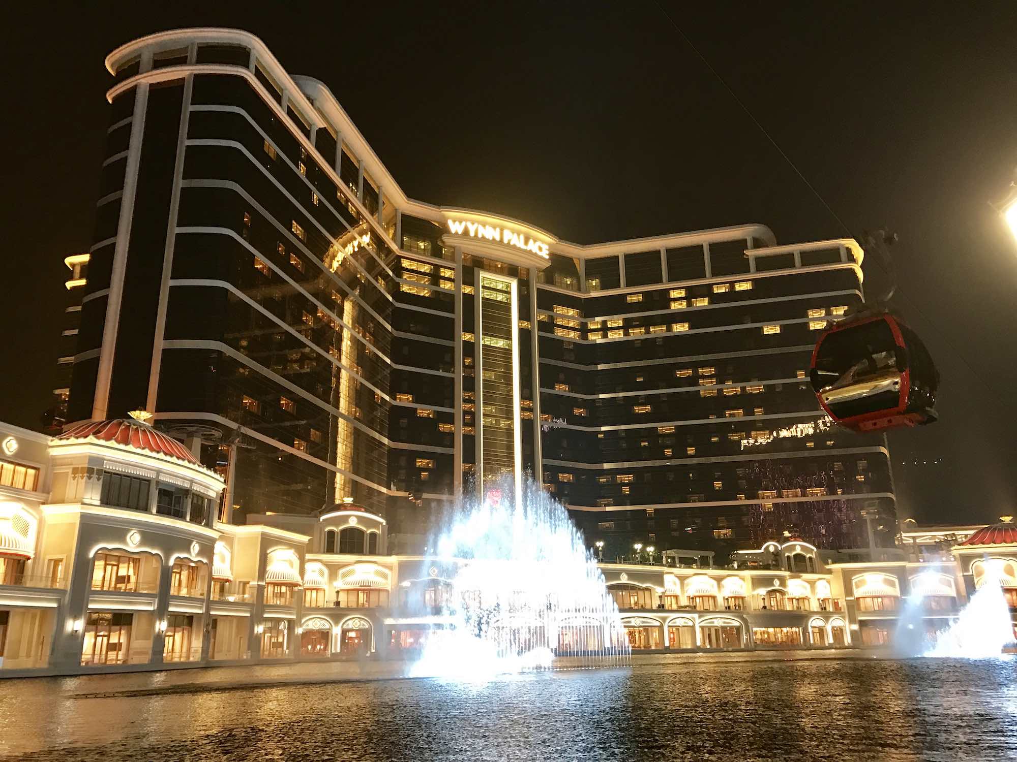 Night time image of Wynn Palace resort with water fountain in foreground