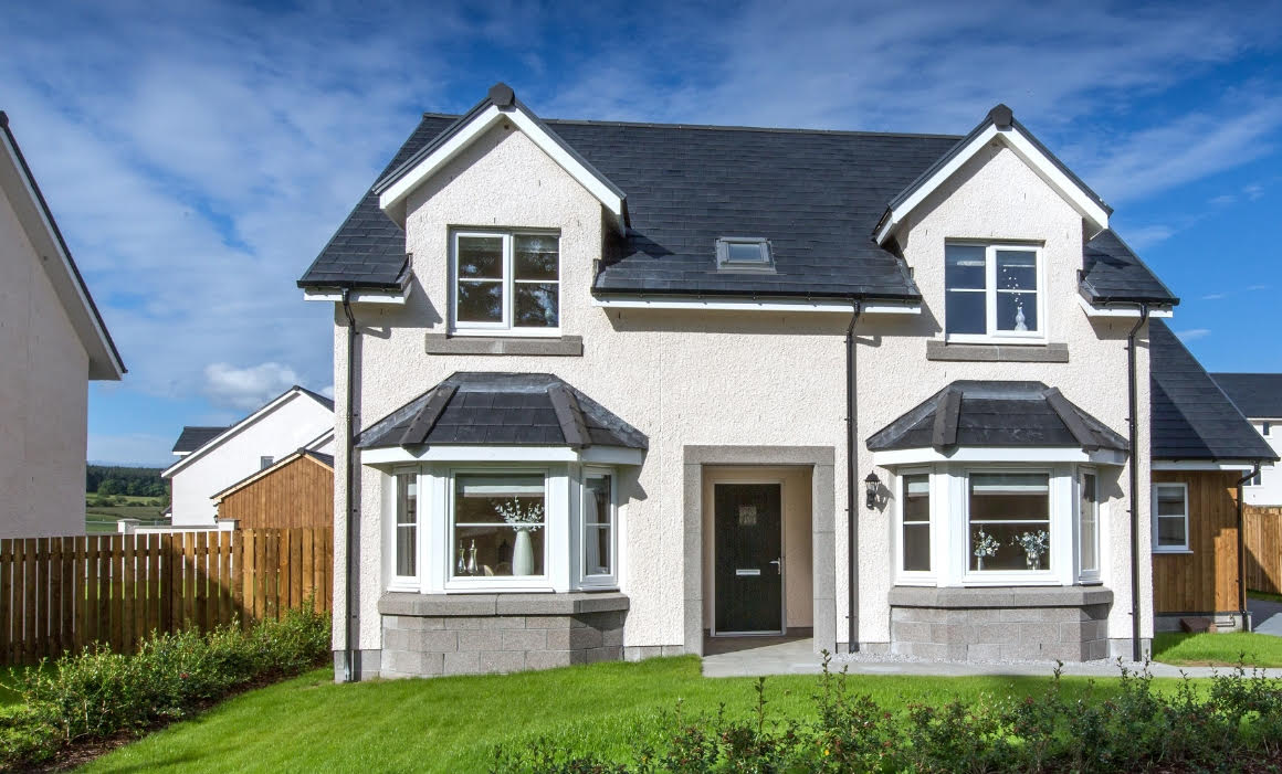 Grass to foreground and wooden fence along left side of residential building with light render finish and PVCu expansion joint