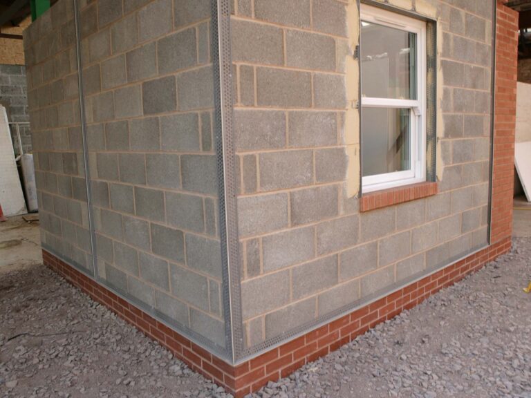 External view of small square breeze block structure with red brick to base and window on right hand side