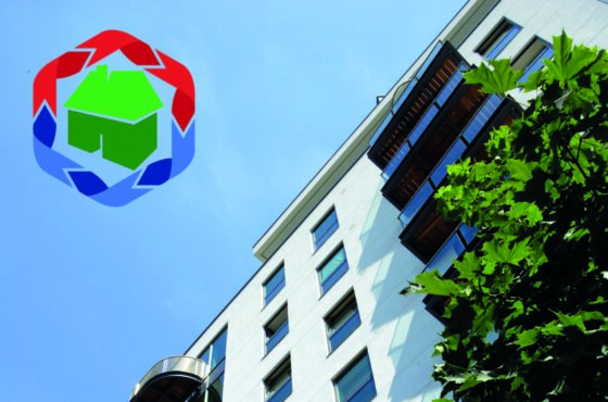 White rendered building with balcony to front, blue sky with renderplas sustainability icon in top right hand corner