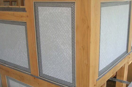 Internal construction of oak frame building with PVCu render beading attached to oak frame