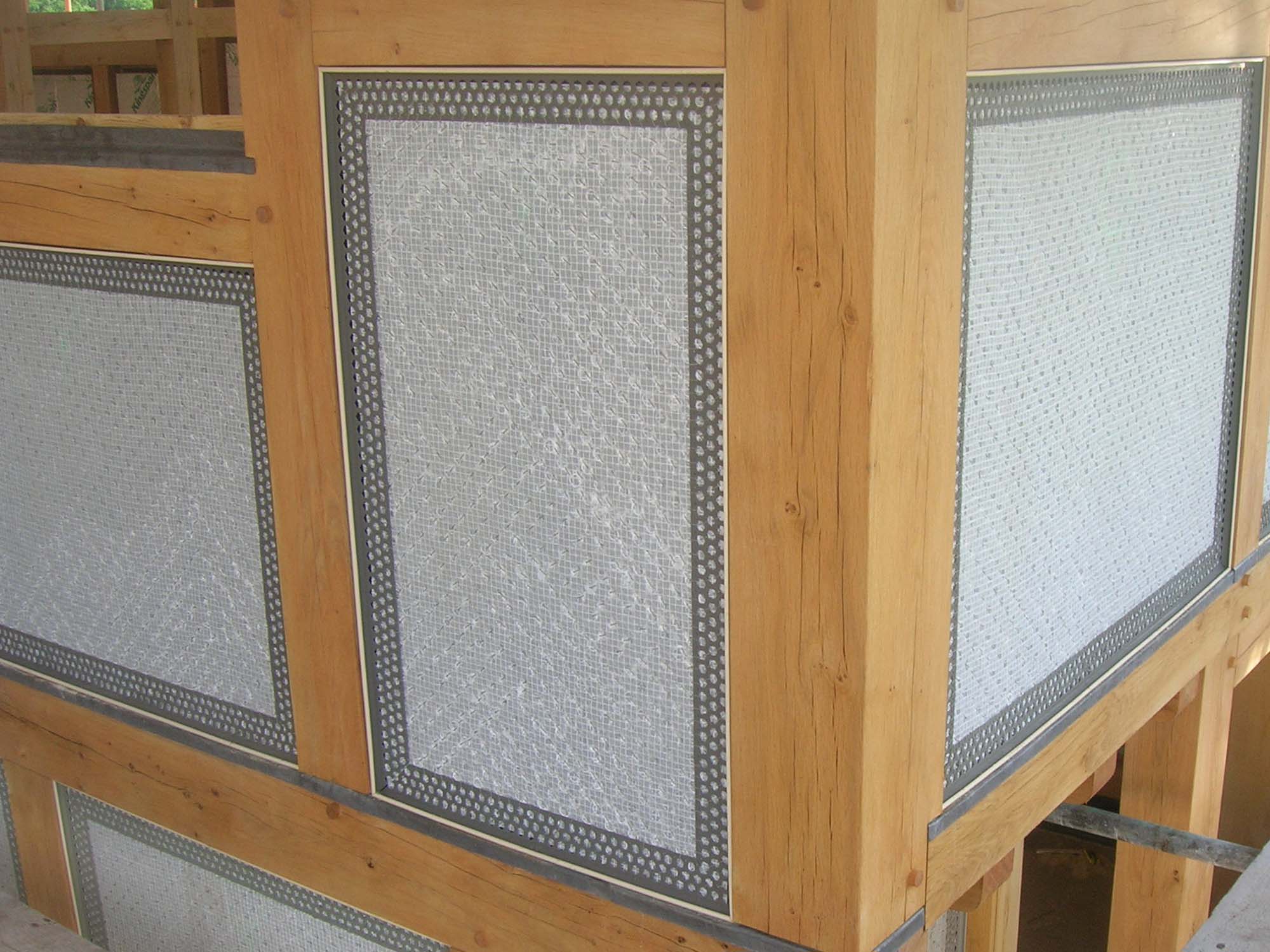 Internal construction of oak frame building with PVCu render beading attached to oak frame