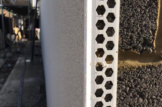 Close up image of white PVCu corner bead on breeze block with render applied to one side